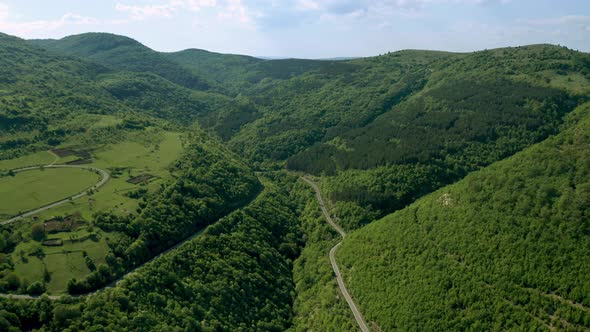 Picturesque spring valley between green hills