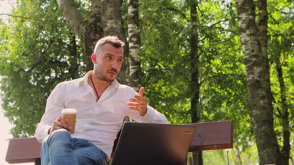 Business Man in a White Shirt Talking Online and Gesturing with His Hands