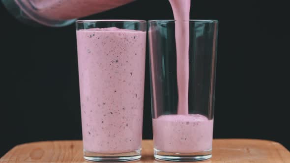 Milkshake with Berries is Poured Into Glasses