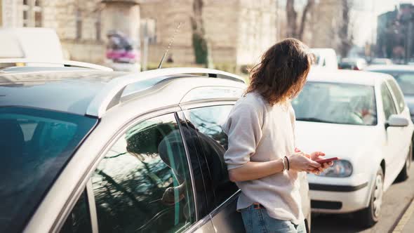 A Young Woman Unlocking the Car with a Key and Sits at the Driver's Seat