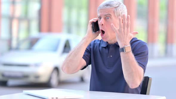 Outdoor Angry Middle Aged Businessman Screaming on Smartphone