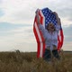 Happy Patriotic Young Woman Waves the US Flag and Jumps Into the Field - VideoHive Item for Sale