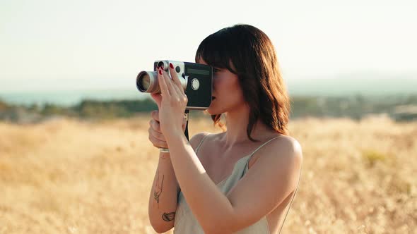 Girl with Short Hair Makes Vintage Video with 8Mm Camera in the Countryside