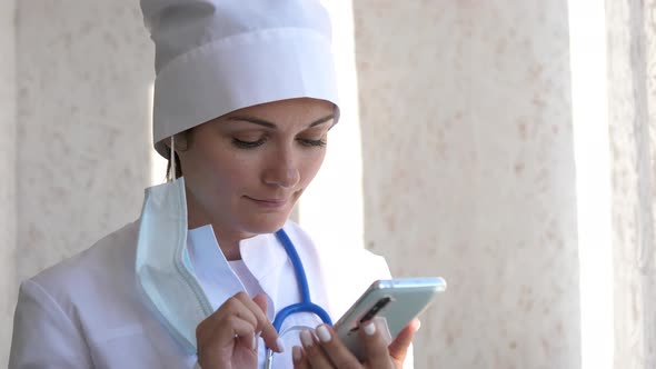 Doctor Using Mobile Phone Texting To Patient Informing About Medical Test Results