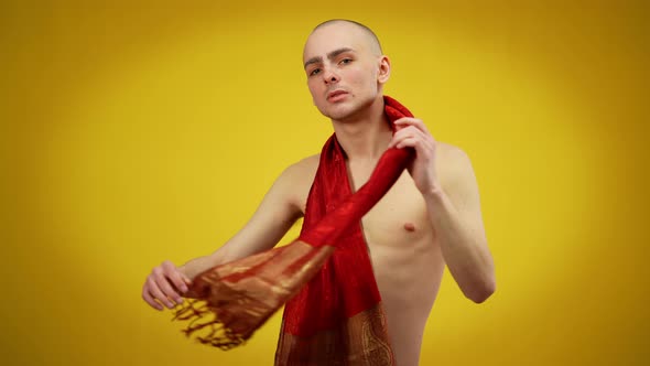 Young Caucasian Male Naked Queer Posing with Red Scarf at Yellow Background