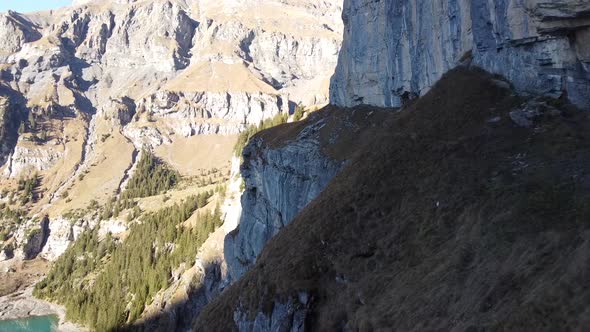 Drone flight along a dangerously steep mountain hiking path in the lush green Swiss mountains above