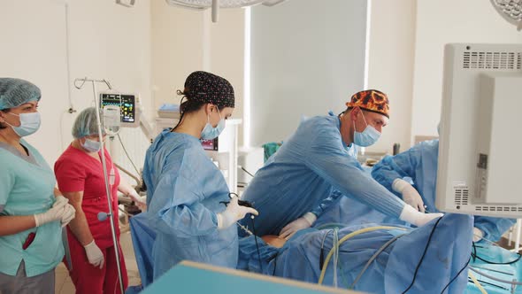 Cooperating of Doctors and Surgeons Processing Surgical Operation in Operating