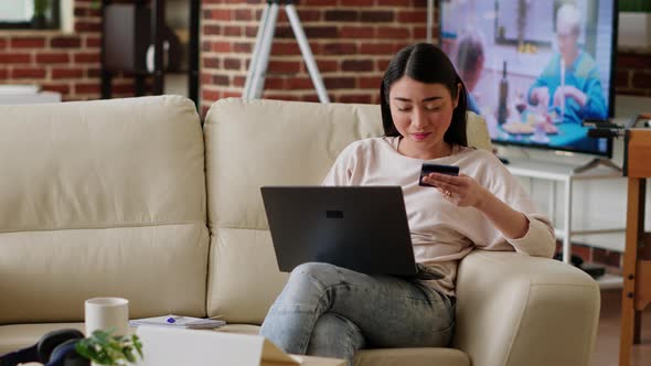 Joyful Woman Inserting Credit Card Credentials on on Shopping Site for Online Payment