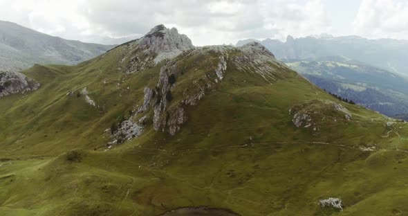 Aerial Drone Flight Establisher Over Lake and Green Cloudy Mountains Peaks