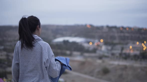 Woman Resting After Exercising Outdoors and Drinking Water After Sunset