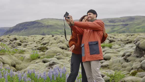 Couple Posing For Selfie With Camera In Mossy Landscape