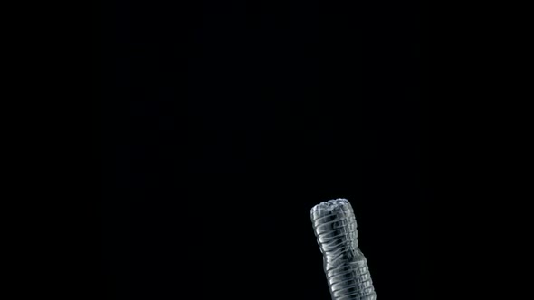 Tossing empty water bottle into trash can, Slow Motion alt