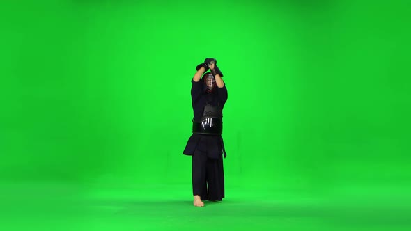 Masculine Kendo Warrior Practicing Martial Art with the Bamboo Bokken on Green Screen.