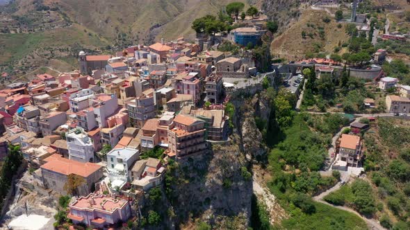 View of Castelmola village, near Taormina, Italy. High View of medieval houses on top of the cliff.