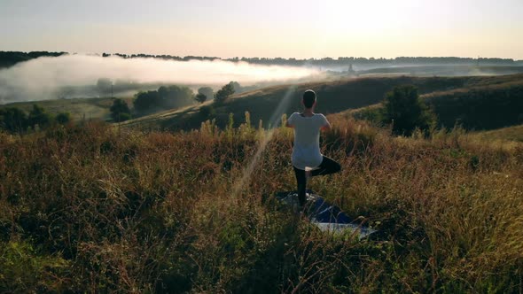 Aerial View on Girl Doing Yoga Outdoors