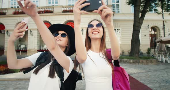 Two Tourist Girls Taking Photo on Phone