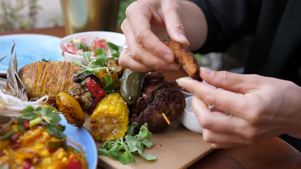 Hand Dipping Piece of Soy Meat in Various Sauces