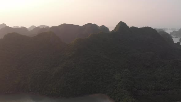 Aerial: unique flying over Ha Long Bay and Cat Ba island at sunset, famous tourism destination in Vi
