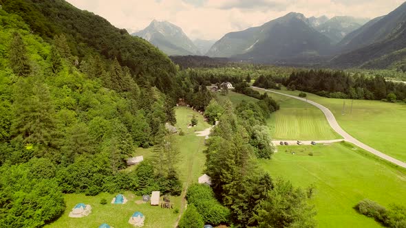 Aerial view of a summer camp with tents located in a valley near the Soca River.