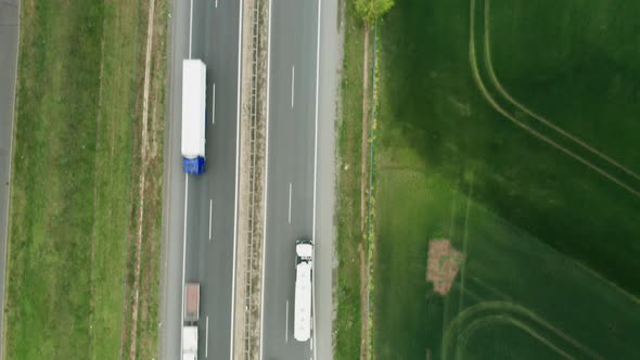 Top View on the Traffic on Highway Between Green Fields