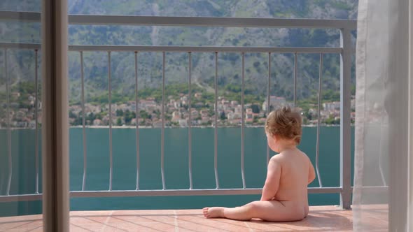 Baby Toddler Boy Sitting on Balcony at Tropical Beach Resort