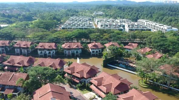 Drone footage of mix white and red houses with the green scenic view plus water and little fountain