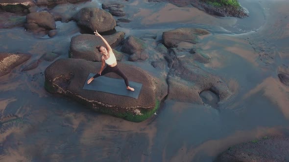 Woman Doing Sports on Rocky Shore