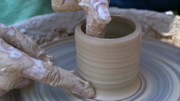 Potter's Hands Work with Clay on a Potter's Wheel. Slow Motion