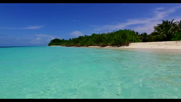 Aerial drone shot landscape of relaxing tourist beach vacation by blue sea with white sandy backgrou