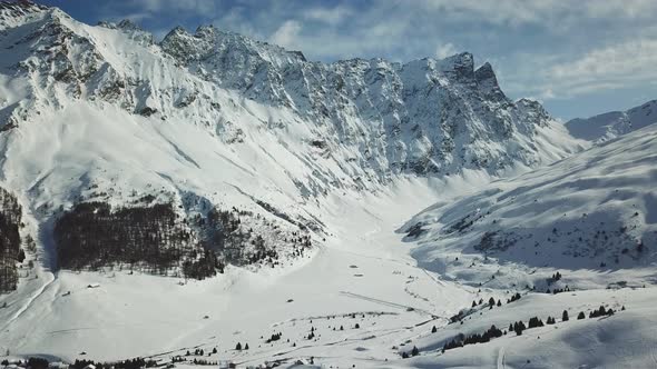 Aerial drone view of snow covered mountains in the winter.