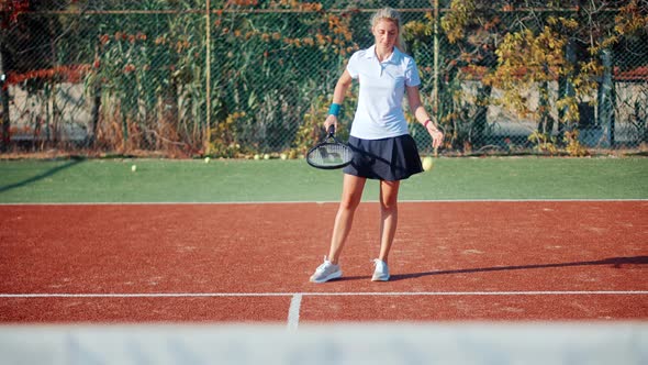 Female Tennis Player Exercising Set Ready To Serve Ball. Girl With Rocket Playing On Tennis Court.