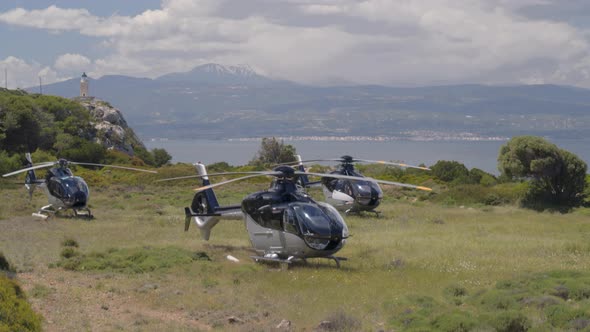 Rising Pan of Parked Helicopters to an Aerial View of a Lighthouse on a Cliff