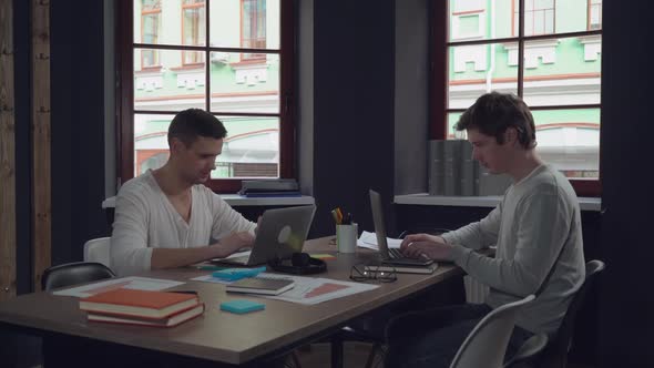 Two Workers Use Pc Indoors