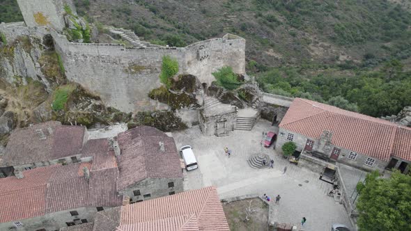 Pillory in square of Sortelha historical village with medieval tower ruins, Portugal. Aerial top-dow