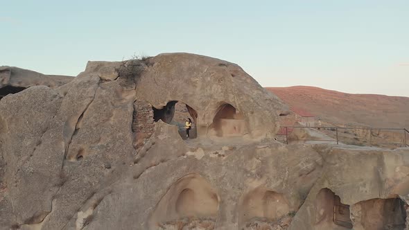 Revealing view of tourist standing in cave city (Upistsikhe)