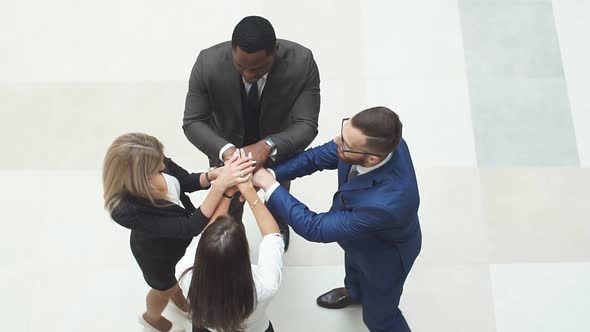 Business People Doing a Team Building Then Putting Their Hands on Top of Each Others.