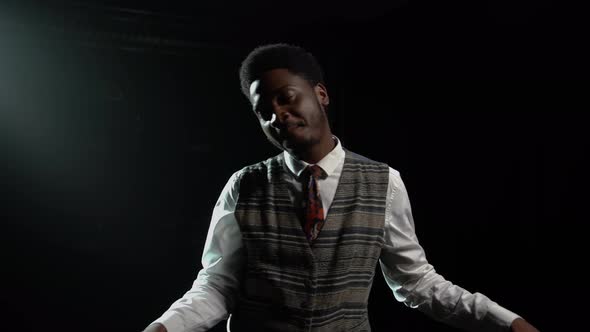 African American Man in Stylish Retro Suit Sings a Song and Gestures with His Hands