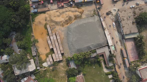 Drone pushes in on Construction site, gravel, sand. Bird's Eye View