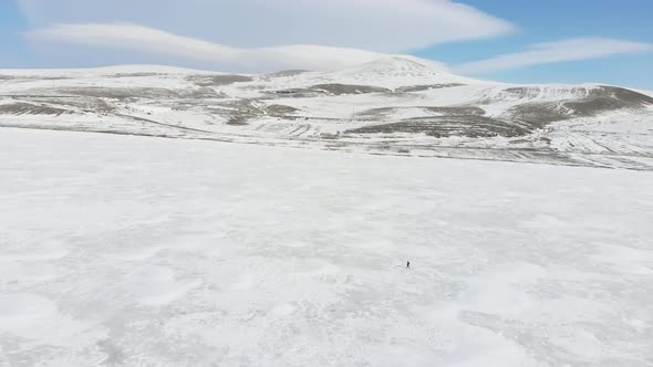 Person Walks On Frozen Lake In Georgia