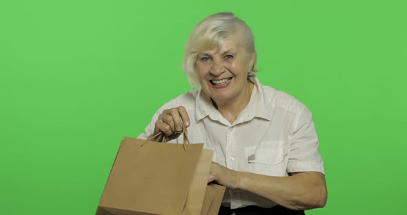 An Elderly Woman with Shopping Bags. Shopping. Presents. Chroma Key