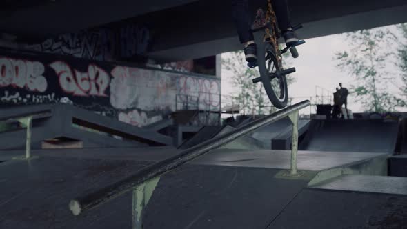 Young Hipster Riding on Bmx Bike at Urban Skate Park