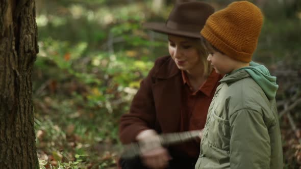 Mother and son are in autumn season forest