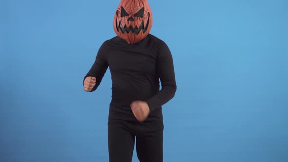 Dancing Pumpkin Man on a Blue Background