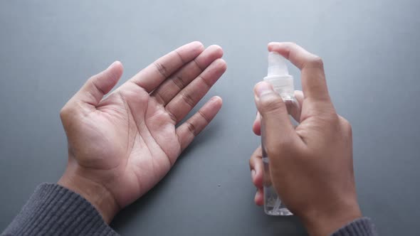 Close Up of Young Man Hand Using Hand Sanitizer Spray