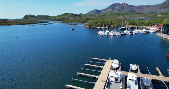 Ascending arial view inside harbor of Ringstad in Northern Norway, Beautiful summer view in Scandina