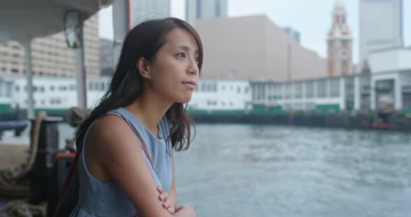 Woman take ferry in Hong Kong city