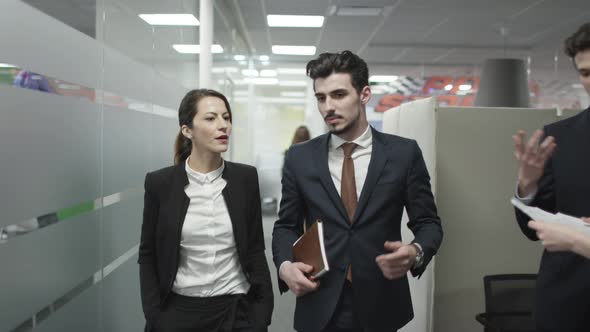 Businessman and businesswoman walking