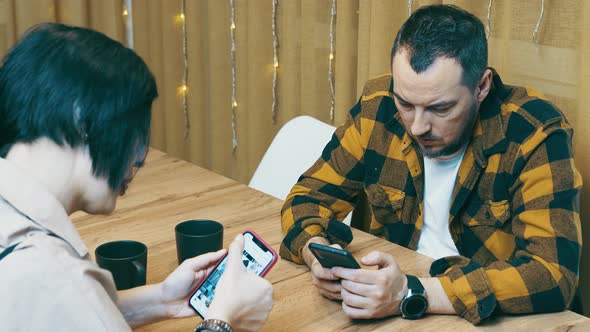 Young Couple of Modern People Spend Time Together with Mobile Phone