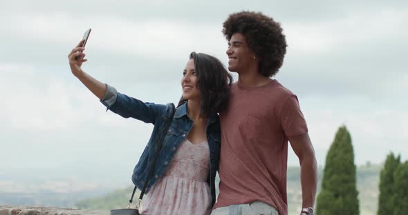 Romantic Couple Taking a Selfie with Smartphone in Rural Town of Assisi.Portrait Medium shot.Friends