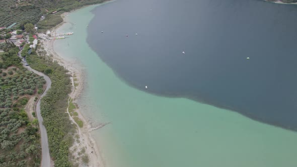 Aerial view of the lake among mountain cliffs. Different water colors of pond. Untouched nature.